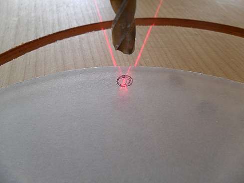 Close-up showing laser centered onto mark on baffle before drilling - 40 (Click to go to page)