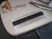 The rough cut 13"L x 4.5"W dovetail plate being fitted with thwe the dovetail bar.