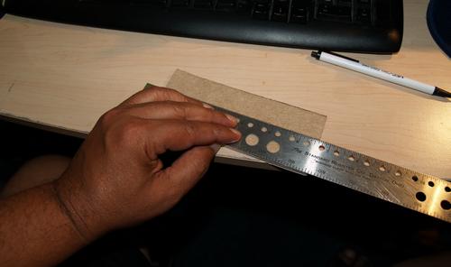 Measuring the adhesive backed felt lining for the cradle rings before trimming.